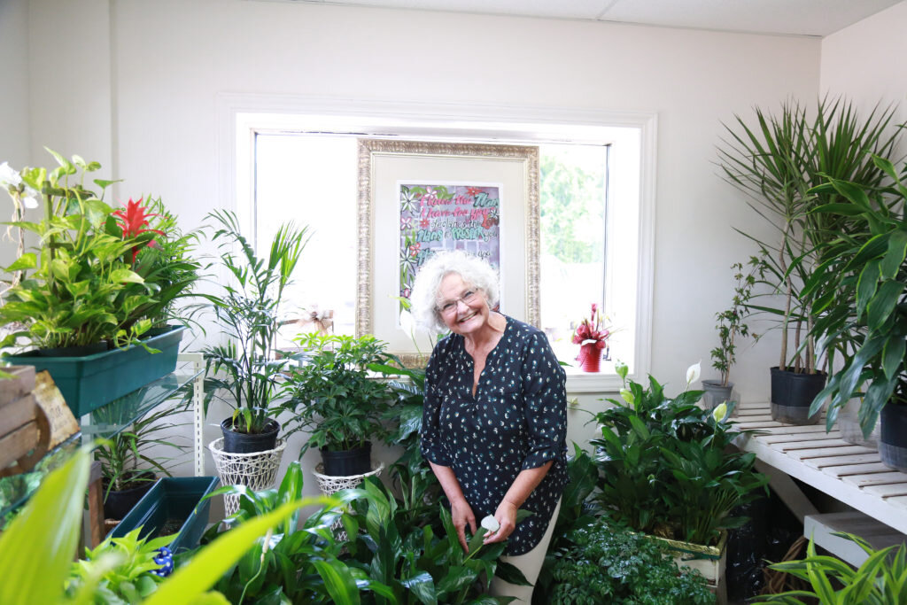Donna Nolen flashes a bright smile in the flower business her mother founded 35 years ago. 