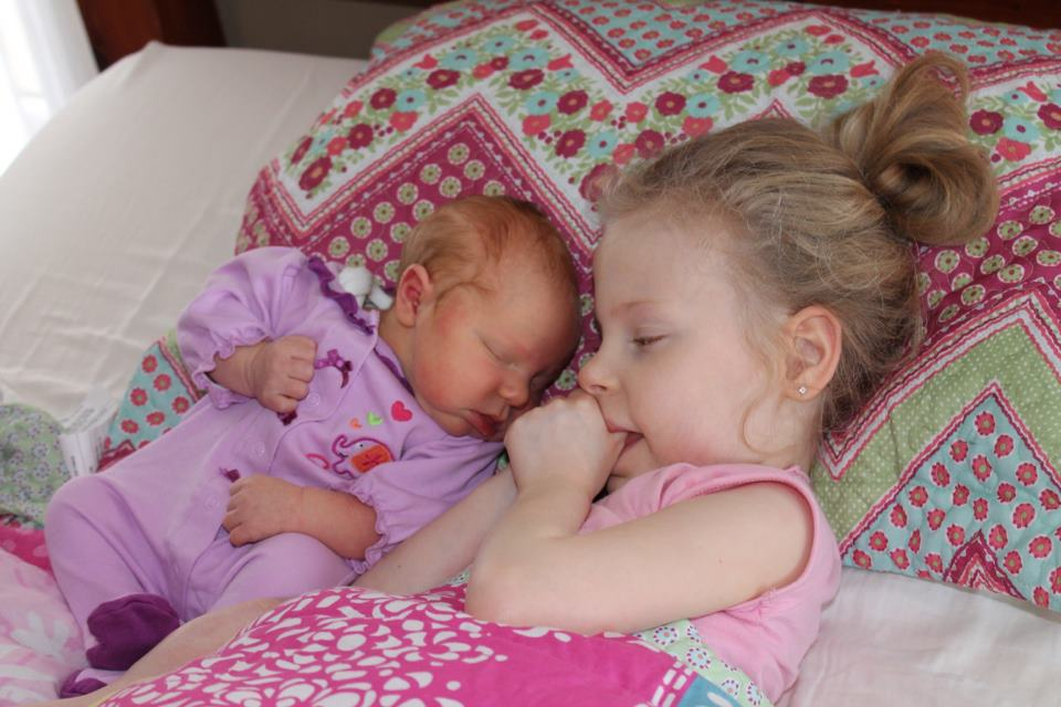 Seven-year-old Emily loves on her baby sister Brooklyn the first day Kim and Nathan bring their newborn baby home in March.