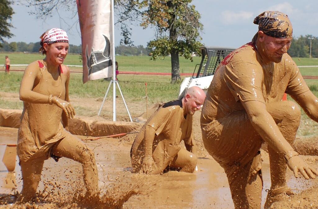 Jeremy and his wife Kelly slosh through the muddy pits of the popular Warrior Dash 