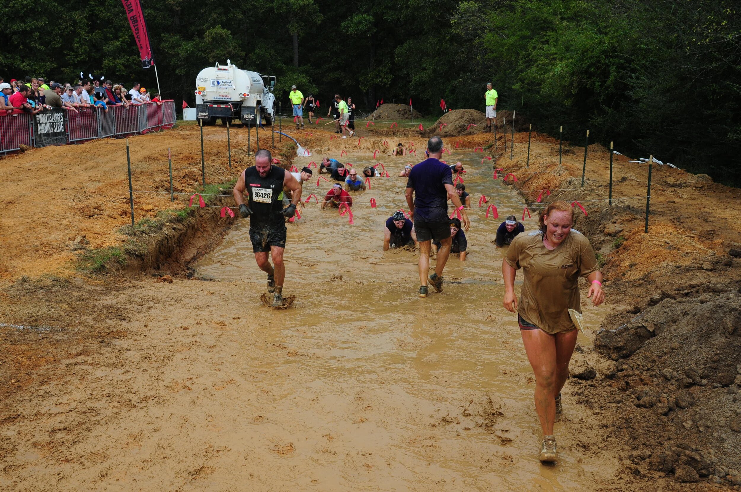 My daughter Morgan emerges from the last mud pit before she crosses the finish line.