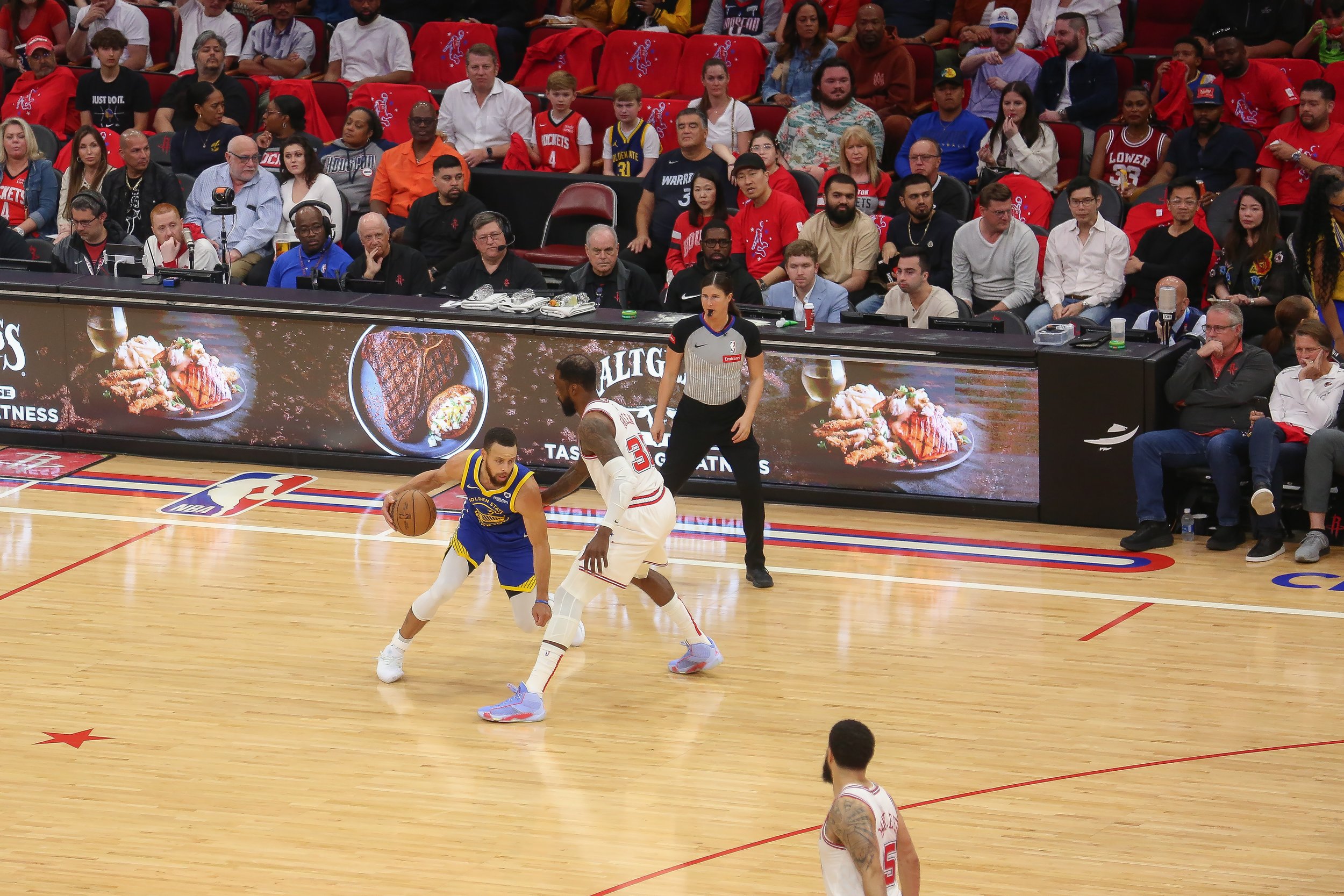   Samford watches on as Warriors guard Steph Curry makes a move on a Rockets defender.  